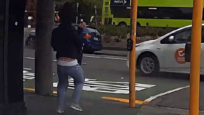 Wind shoves woman into the street in Wellington, New Zealand.