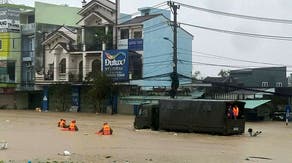 See It: Police rescue baby from deadly flooding that killed at least 41 in Central Vietnam