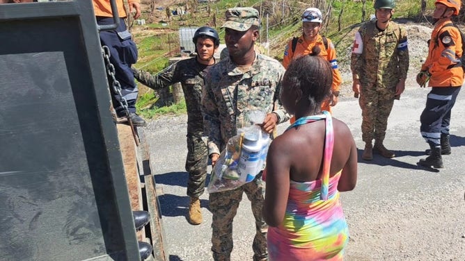 Members of the El Salvador military work to hand out food and water to Jamaicans affected by Hurricane Melissa on Nov. 10, 2025.