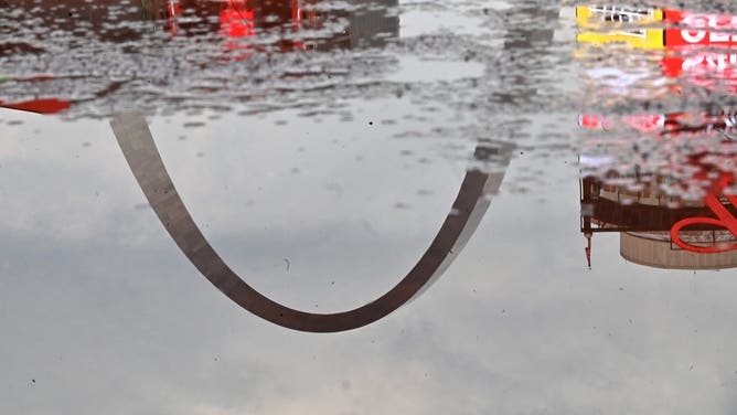 ST. LOUIS, MO - JULY 15: The St. Louis Gateway Arch is reflected in a puddle of water left on the infield after a rainstorm before the second game of a MLB doubleheader between the Washington Nationals and the St. Louis Cardinals on July 15, 2023, at Busch Stadium in St. Louis, Mo. (
