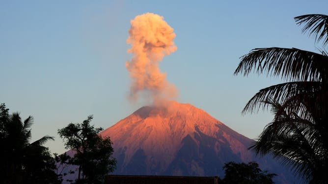FILE - This photo taken on Oct. 1, 2023 shows volcanic materials spewing from Mount Semeru, as seen from Lumajang, East Java, Indonesia. 
