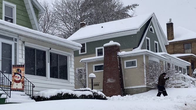 CANAJOHARIE, NEW YORK, UNITED STATES - JANUARY 07: A snowman flag is seen on the front of a house during a powerful winter storm which brought as much as 14 inches of snow to the Northeast, on January 7, 2024 in the village of Canajoharie, N.Y.