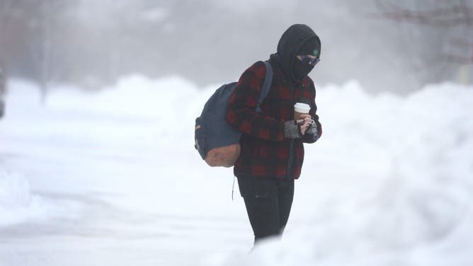 WEST DES MOINES, IOWA - JANUARY 13: Motorists navigate through blowing snow during a cold windy day on January 13, 2024 in West Des Moines, Iowa.