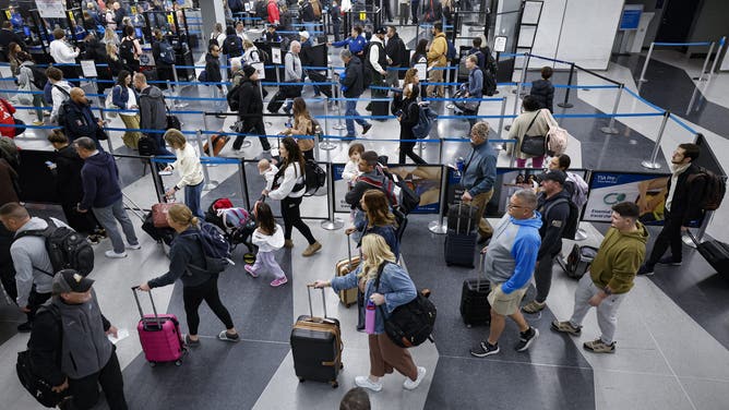 Travelers line up at the security checkpoint at O'Hare International Airport in Chicago, Illinois, on November 22, 2024, ahead of the upcoming Thanksgiving holiday.
