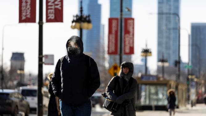 People bundled up walk on a street in Chicago, the United States, on Feb. 18, 2025. Despite the sunshine, it is likely the coldest day of this week in Chicago on Tuesday, with the highest temperature being minus 23.9 Celsius degrees and the lowest plunging to minus 28.3 Celsius degrees. The wind chill is at minus 31.6 Celsius degrees. 