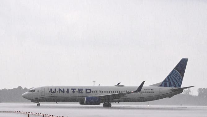 A United Airlines plane is seen after landing during a heavy rain at George Bush Intercontinental Airport on July 25, 2025, in Houston, Texas.