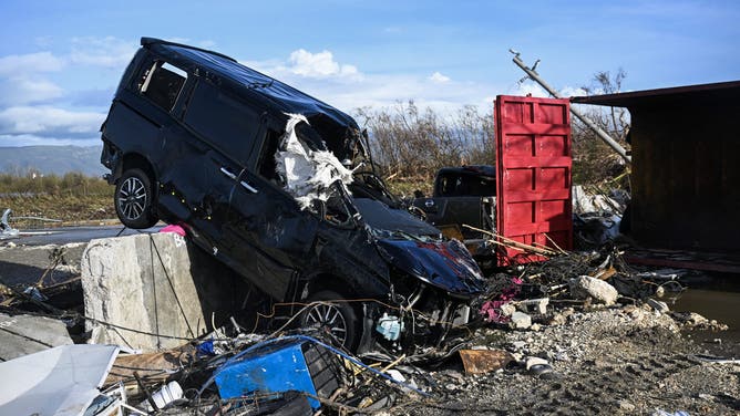 A car and surrounding buildings are seen damaged following the passage of Hurricane Melissa, in Black River, St. Elizabeth, Jamaica on October 29, 2025. Hurricane Melissa bore down on the Bahamas October 29 after cutting a path of destruction through the Caribbean, leaving 30 people dead or missing in Haiti and parts of Jamaica and Cuba in ruins.