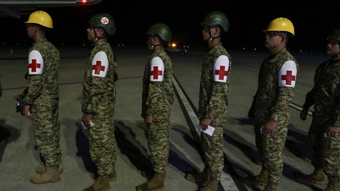 LA PAZ, EL SALVADOR - OCTOBER 31: Members of the Armed Forces medical unit boarding an airplane during the dispatch of a humanitarian aid contingent to Jamaica after Hurricane Melissa, at the Oscar Arnulfo Romero International Airport, in La Paz, El Salvador on October 31, 2025. According to an announcement by Salvadoran President Nayib Bukele, more than 300 rescuers and more than 50 tons of supplies would be sent to Jamaica as humanitarian aid, after Hurricane Melissa caused dozens of deaths, missing persons and infrastructure damage in several Caribbean countries such as Jamaica, Haiti, Cuba and others. (Photo by Alex Pena/Anadolu via Getty Images)
