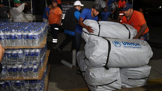 LA PAZ, EL SALVADOR - OCTOBER 31: Members of Civil Protection and the Government of El Salvador unloading supplies from trucks during the dispatch of a humanitarian aid contingent to Jamaica after Hurricane Melissa, at the Oscar Arnulfo Romero International Airport, in La Paz, El Salvador on October 31, 2025. According to an announcement by Salvadoran President Nayib Bukele, more than 300 rescuers and more than 50 tons of supplies would be sent to Jamaica as humanitarian aid, after Hurricane Melissa caused dozens of deaths, missing persons and infrastructure damage in several Caribbean countries such as Jamaica, Haiti, Cuba and others. (Photo by Alex Pena/Anadolu via Getty Images)