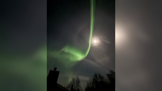 The northern lights dazzled in front of the Supermoon in Anchorage, Alaska on Thursday, Nov. 6, 2025.