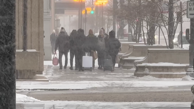 People walking through heavy snow in Chicago on Saturday.