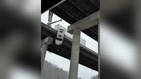 Must-watch: Truck driver rescued dangling off West Virginia highway 100-feet above the ground below