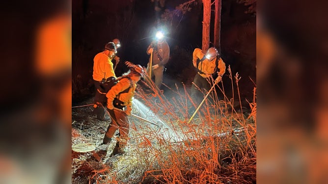 Firefighters respond to small wildfire in Evergreen, Colorado on Wednesday, Dec. 17, 2025.