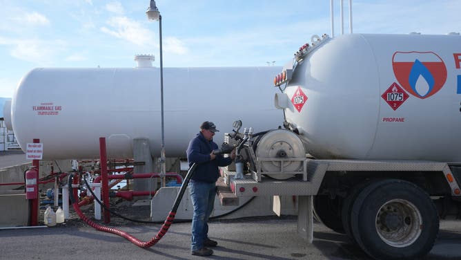A worker fills a propane deliver truck at a Freeway Propane facility in Springville, Utah, U.S., on Wednesday, Oct. 20, 2021.