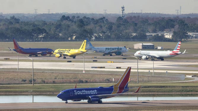 Airliners wait for takeoff in a queue at runways 36L and 36R at Orlando International Airport, Wednesday, Jan. 11, 2023, after the FAA grounded all U.S. flights earlier in the day.