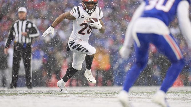 ORCHARD PARK, NY - JANUARY 22: Joe Mixon #28 of the Cincinnati Bengals runs with the ball against the Buffalo Bills during the first half at Highmark Stadium on January 22, 2023 in Orchard Park, New York.