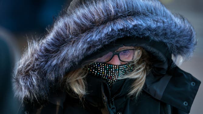 FILE - Boston, MA - January 17: A commuter is bundled for the cold outside South Station.