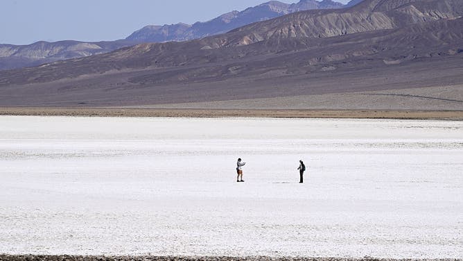 DEATH VALLEY, CALIFORNIA - MAY 29: Tourists visit Badwater Basin as 'Extreme Heat Warning' issued in Death Valley National Park of California, United States on May 29, 2025.