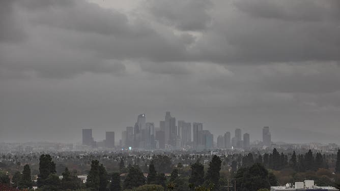 LOS ANGELES, CALIFORNIA - NOVEMBER 20: Rain falls from storm clouds over downtown as seen from the Baldwin Hills neighborhood on November 20, 2025 in Los Angeles, California, during multiple days of a storm that triggered evacuation and flash flood warnings in Southern California.