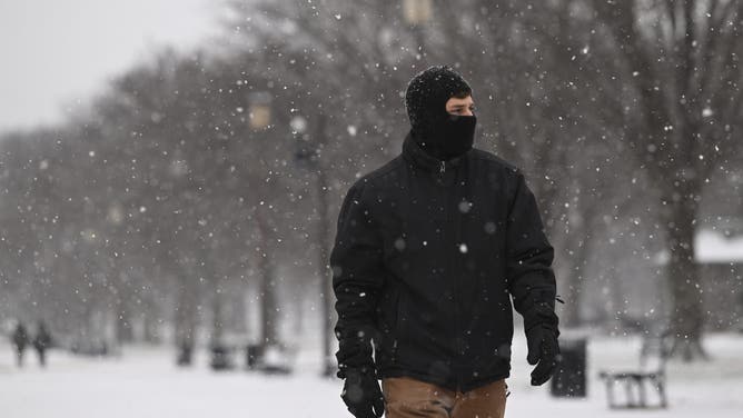 WASHINGTON DC, UNITED STATES - DECEMBER 5: People walk around the US Capitol building during a snowy weather in Washington DC, United States on December 5, 2025.