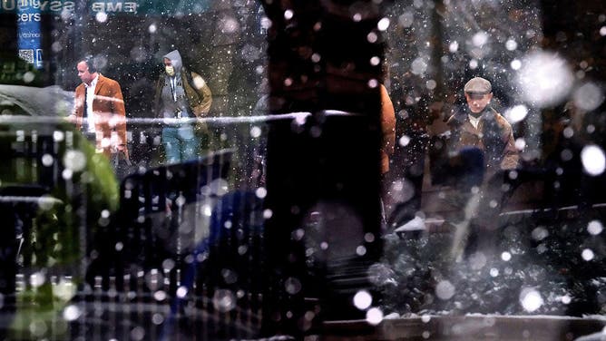 ALEXANDRIA, VA - DECEMBER 5: Commuters are seen through the window of a bus at the King Street Metro station as snow falls on Friday, December 5, 2025, in Alexandria, VA.