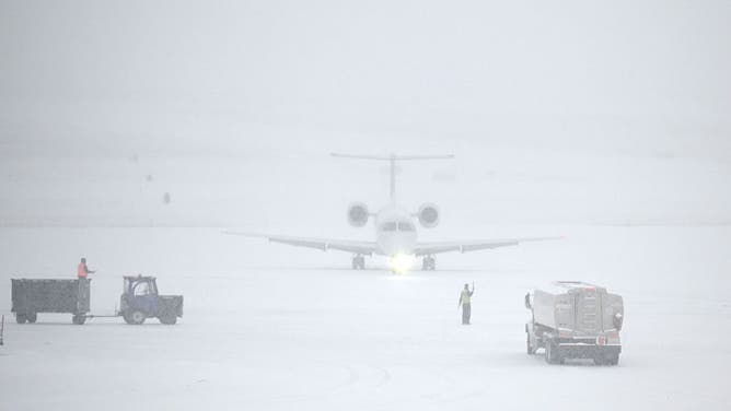 COLONIE, NY - FEBRUARY 6: An American Airlines jet is guided to the gate at Albany International Airport during a winter storm on Tuesday, Dec. 2, 2025, in Colonie N.Y. 