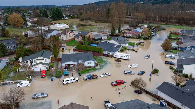 PACIFIC, WASHINGTON - DECEMBER 16: In an aerial view, a neighborhood is engulfed in floodwater on December 16, 2025 in Pacific, Washington. Evacuations have been ordered in 3 suburbs south of Seattle after recent levee failure. Atmospheric rivers are expected to continue in the coming days as northern Washington continues reeling back from historic flooding late last week. Mass flooding along the Pacific Northwest caused historic flooding, tens of thousands of evacuations, and dozens of Coast Guard rescues.