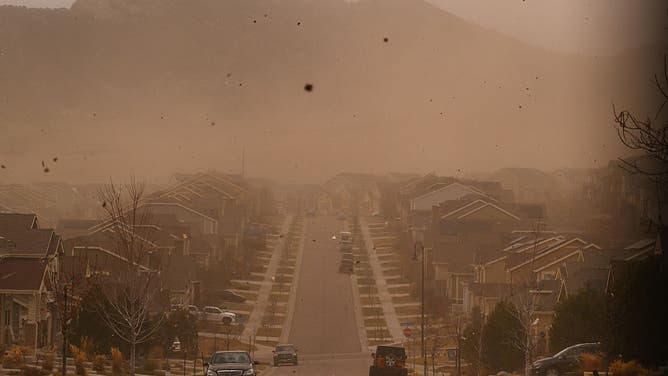 DECEMBER 17: Dust and debris blow through the Leyden Rock subdivision during a strong windstorm in Arvada, Colo., on Dec. 17, 2025. 