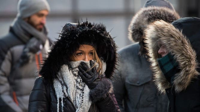 NEW YORK, NY - JANUARY 05: Bundled up pedestrians walk through Times Square, January 5, 2018 in New York City.