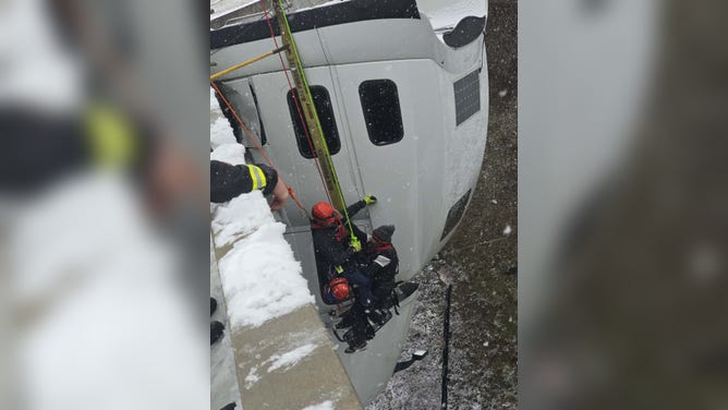 First responders complete a risky rope rescue to evacuate a truck driver after crashing in rough winter weather conditions.