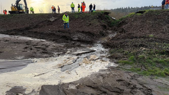 Crews work to repair a levee failure in Washington