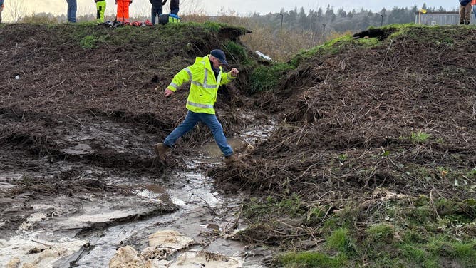 Crews work to repair a levee failure in Washington