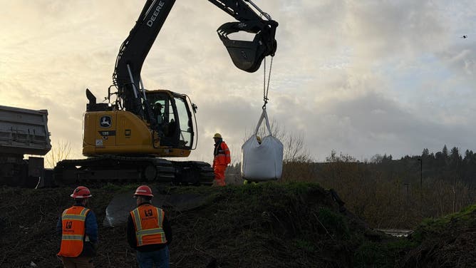 Crews work to repair a levee failure in Washington