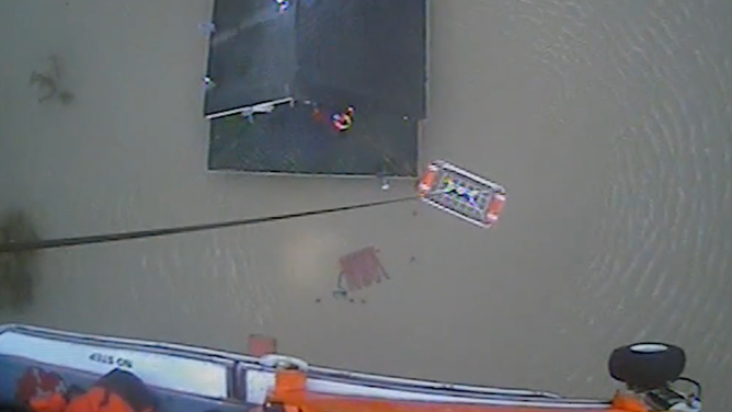 A rescue basket was sent down to hoist the trapped individuals into the helicopter.