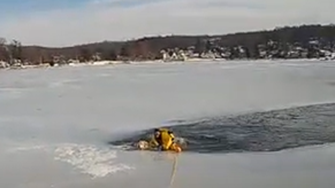 Patrolman Michael Poon enters the icy waters at Lake Mohawk in New Jersey, where a dog is trapped.
