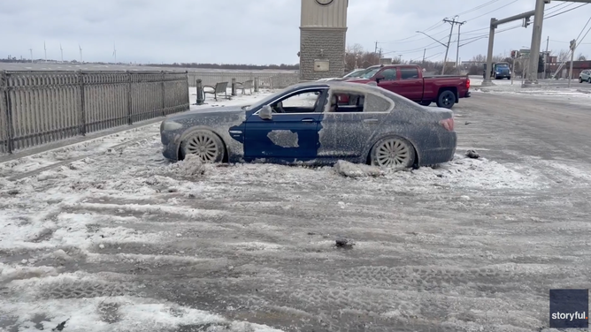Car left at shores of Lake Erie in Athol Springs, NY, freezes to parking lot inside and out.