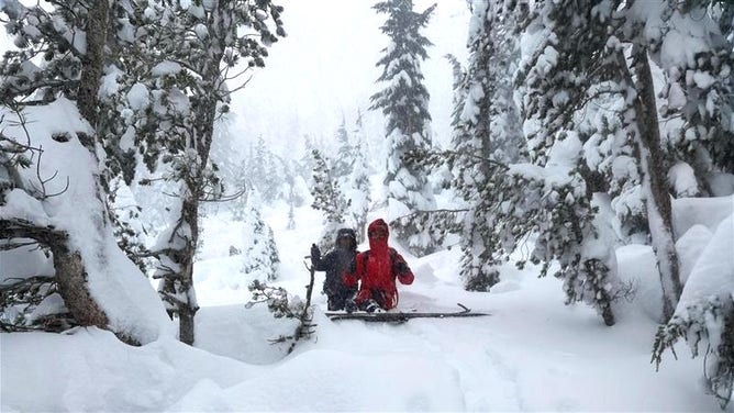 Emergency response teams search for a skier partially buried in an avalanche in Mount Rose Summit, Nevada.