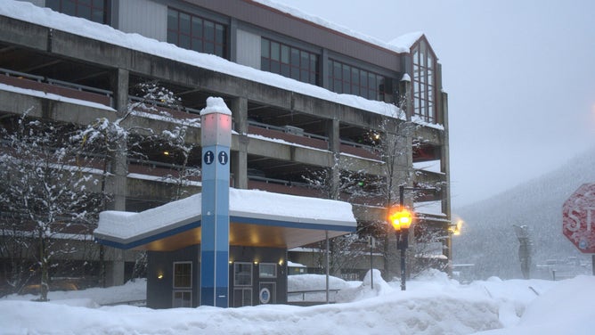 Several feet of snow sit on the roof of a building in Juneau weeks after heavy snow in December 2025.