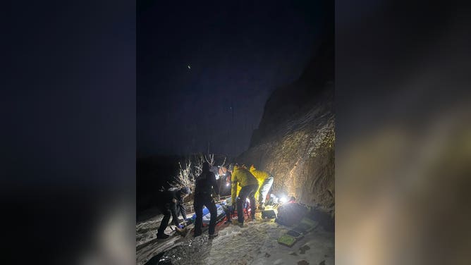 A motorcyclist is prepared by first responders to be airlifted by a medical helicopter.
