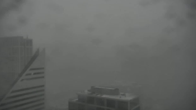 Heavy snow band blankets Chicago skyline Wednesday morning.
