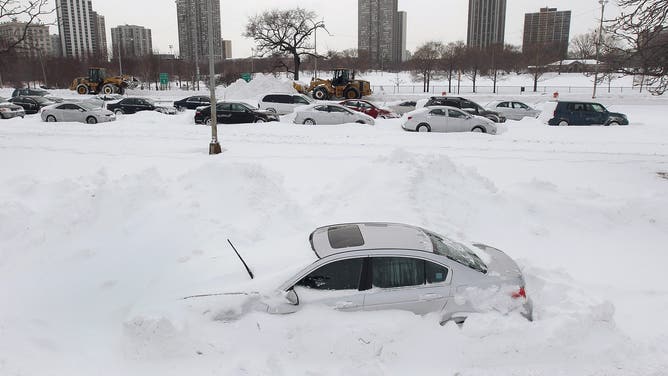 CHICAGO - FEBRUARY 02: A car sits facing the wrong direction on a ramp to Lake Shore Drive as cars in the northbound lanes (rear) of the Drive sit stranded after the road was rendered impassible by accidents and deep snow during last night's blizzard February 2, 2011 in Chicago, Illinois. As of late morning over 20 inches of snow had fallen, making this snowstorm the third largest recorded in the city.