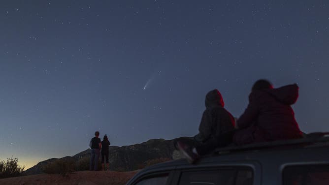 LOS ANGELES, CA - JULY 19: People watch the night sky as Comet NEOWISE appears over the San Gabriel Mountains National Monument on July 19, 2020 northwest of Los Angeles, California.
