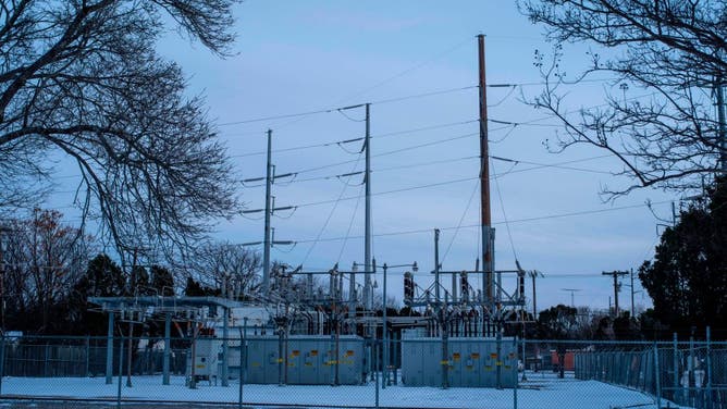 FILE - An Oncor power substation is surrounded by snow in Waco, Texas, on February 18, 2021. - A deadly winter weather system that brought record-busting cold to the southern and central United States, knocking out power for millions in oil-rich Texas, blanketed the East Coast in snow February 18, 2021.