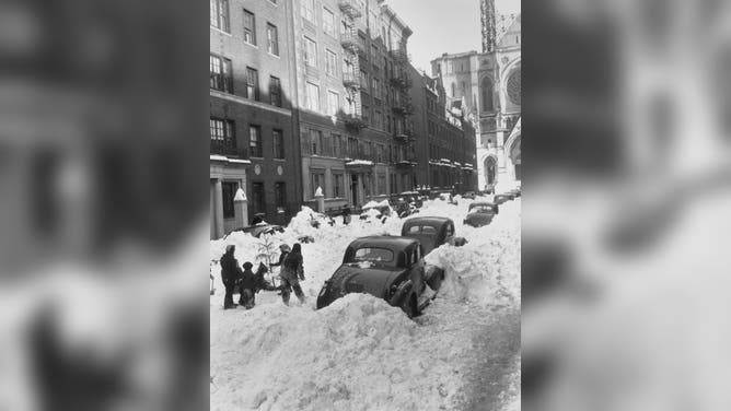 People clearing snow following a snowstorm in New York City, New York, 29th December 1947. The North American blizzard of 1947 brought the northeast of the United States to a standstill, with over 26 inches falling on New York City.