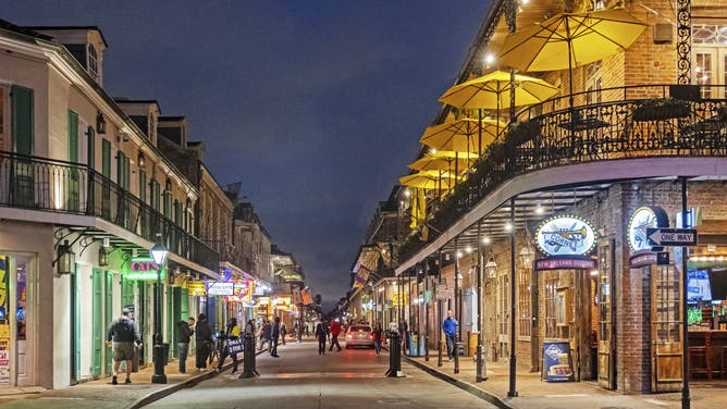 Shops, bars and restaurants at night in Bourbon Street, French Quarter/Vieux Carré in the city New Orleans, Louisiana.