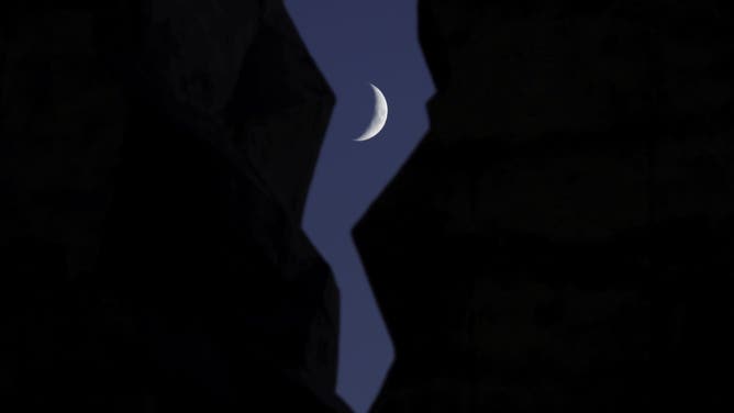 BAYONNE, NJ - OCTOBER 29: A 25 percent illuminated waxing crescent moon sets behind the Tear Drop 9/11 Memorial on October 29, 2022, in Bayonne, New Jersey. 