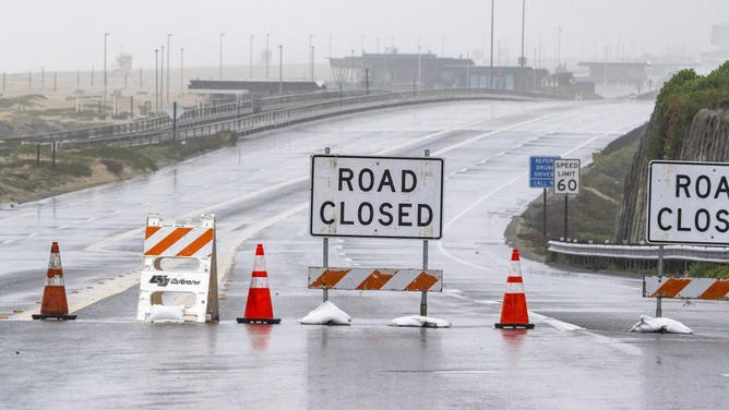 Huntington Beach, CA - February 20: A view from Seapoint Street in Huntington Beach looks north along Pacific Coast Highway which was closed due to coastal flooding on Tuesday, February 20, 2024.
