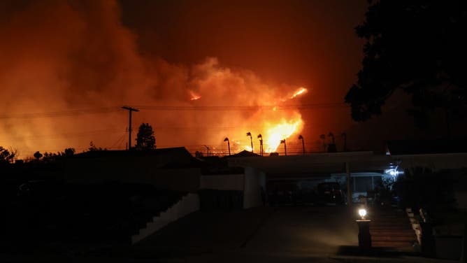ALTADENA, CA - JANUARY 07, 2025: A wind-driven fire burns in the Eaton Canyon area on January 7, 2025 in Altadena, California. Santa Ana wind is fueling a brush fire in the Eaton Canyon area near Altadena on the evening of January 7, prompting mandatory evacuations. 