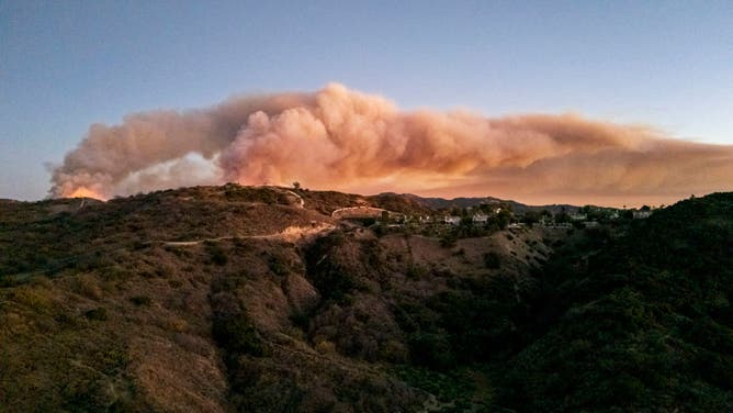 JAN. 10, 2025: Thick smoke rises from the Palisades wildfire in Los Angeles County on January 10, 2025. Tens of thousands of residents have been forced to flee, while emergency crews work to protect homes and critical infrastructure from the advancing flames. 