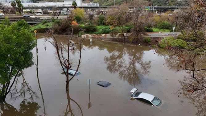 San Diego, CA - January 1: Vehicles parked on Camino De La Reina in Mission Valley were submerged after the San Diego River overflowed and flooded the area during a storm on January 1, 2026 in San Diego, CA.